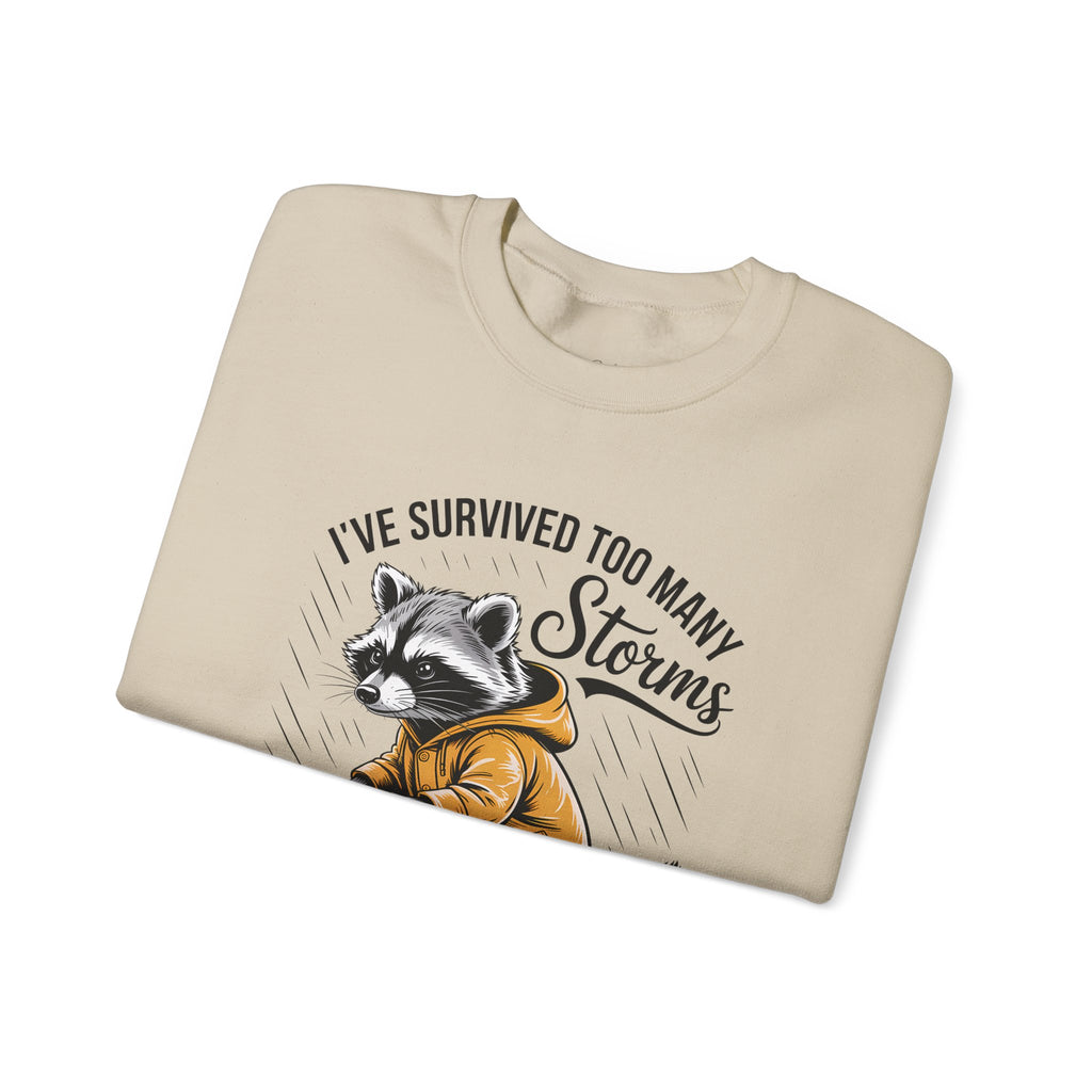 Crewneck Sweatshirt — "I've Survived Too Many Storms" Raccoon Graphic Unisex