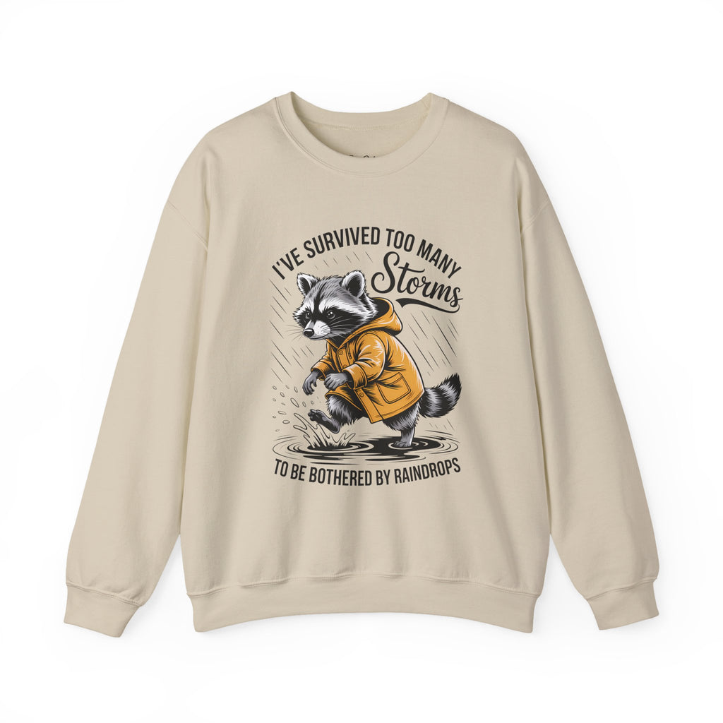 Crewneck Sweatshirt — "I've Survived Too Many Storms" Raccoon Graphic Unisex