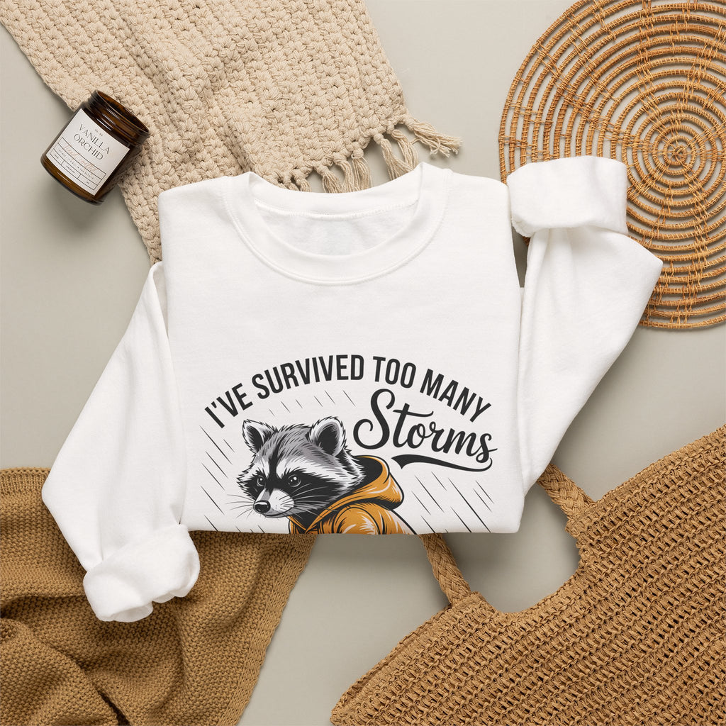 Crewneck Sweatshirt — "I've Survived Too Many Storms" Raccoon Graphic Unisex
