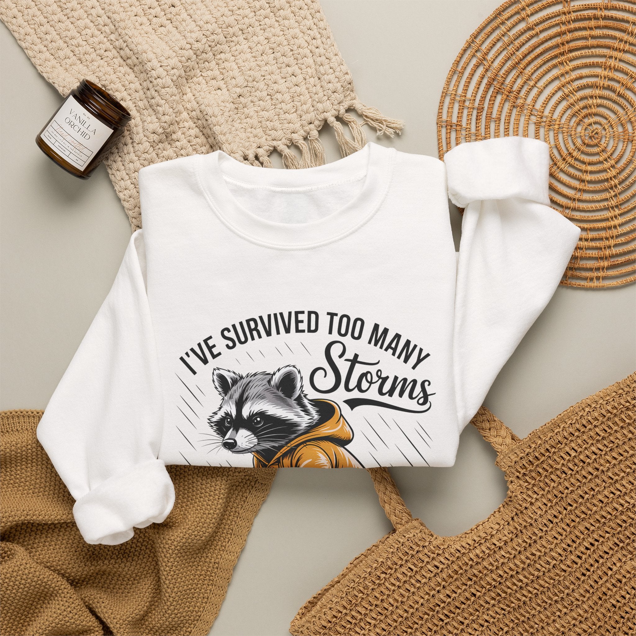 Crewneck Sweatshirt — "I've Survived Too Many Storms" Raccoon Graphic Unisex
