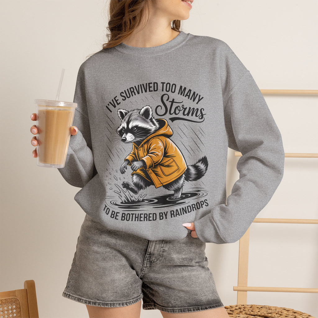 Crewneck Sweatshirt — "I've Survived Too Many Storms" Raccoon Graphic Unisex