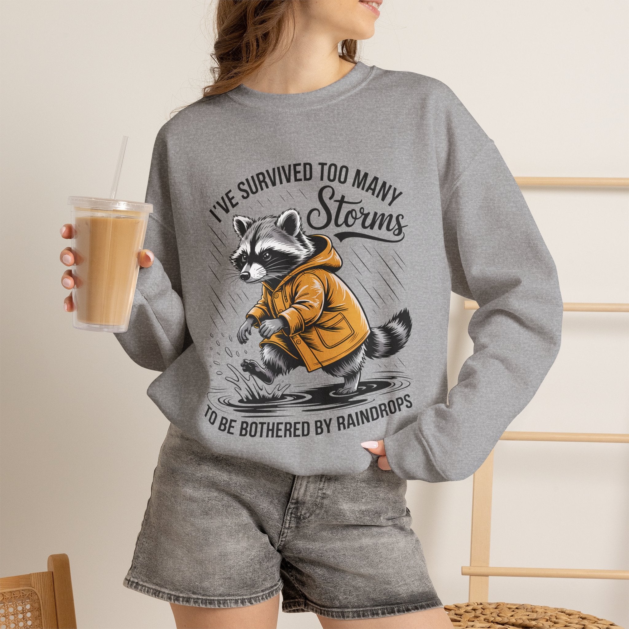 Crewneck Sweatshirt — "I've Survived Too Many Storms" Raccoon Graphic Unisex