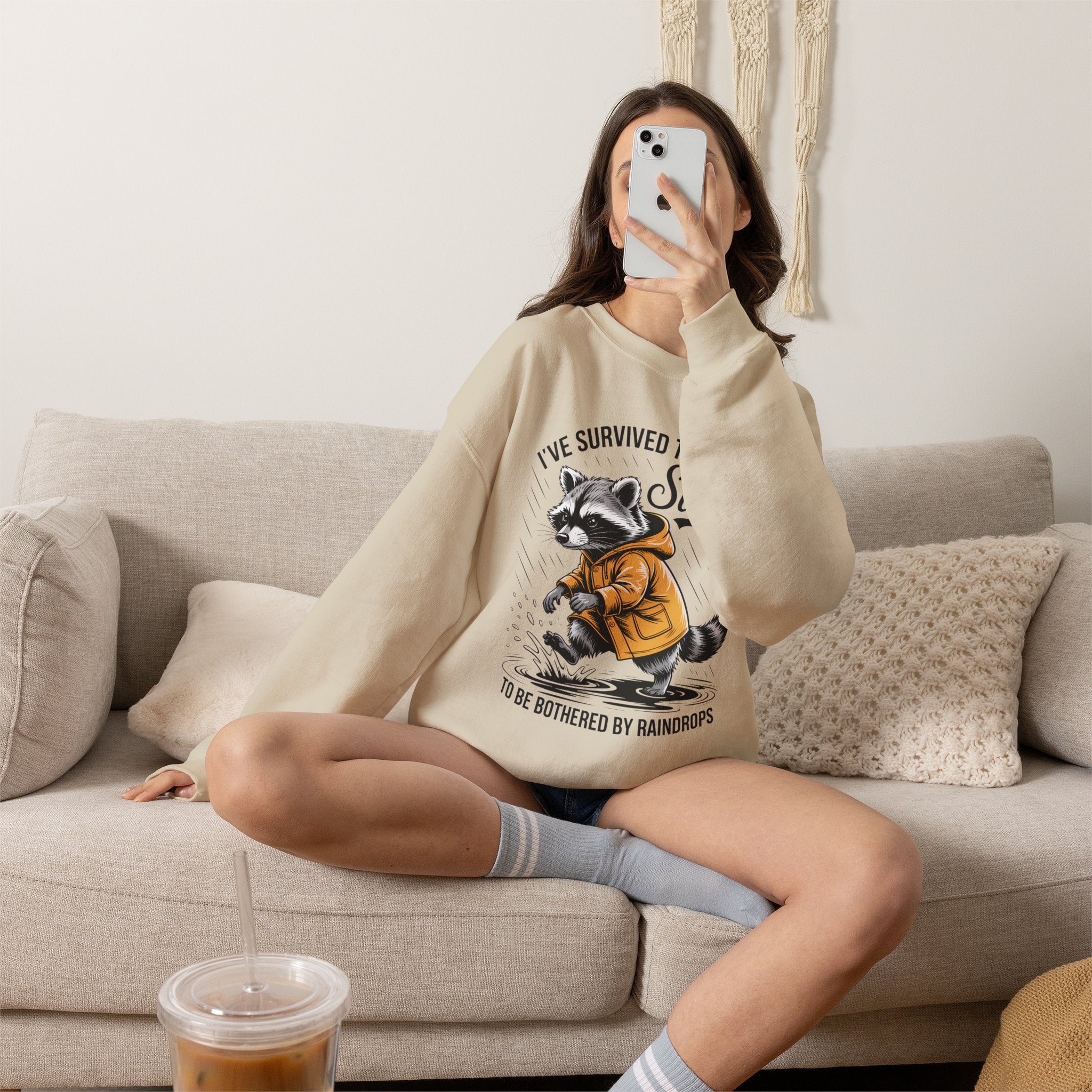 Crewneck Sweatshirt — "I've Survived Too Many Storms" Raccoon Graphic Unisex