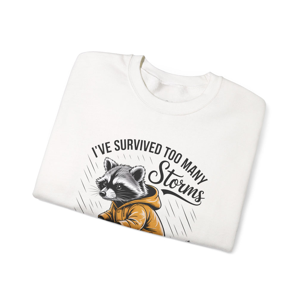 Crewneck Sweatshirt — "I've Survived Too Many Storms" Raccoon Graphic Unisex