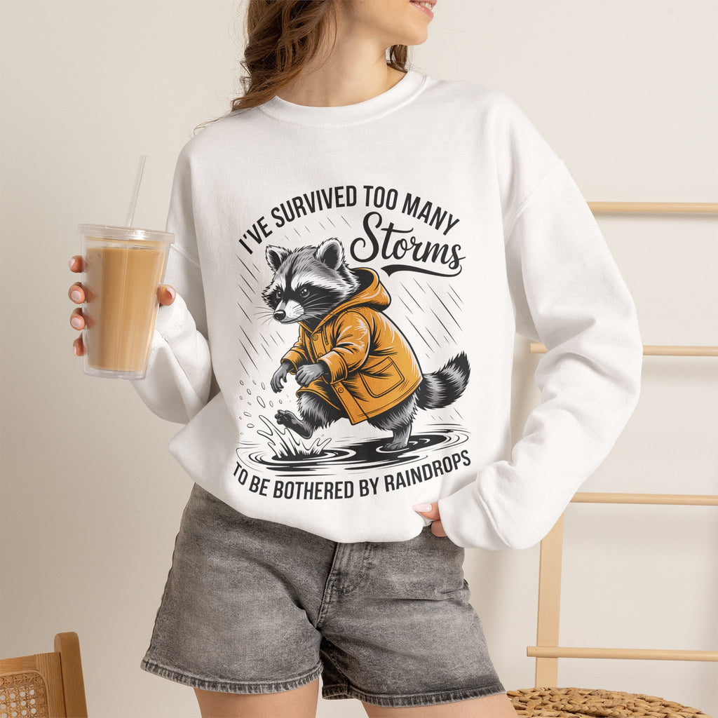 Crewneck Sweatshirt — "I've Survived Too Many Storms" Raccoon Graphic Unisex