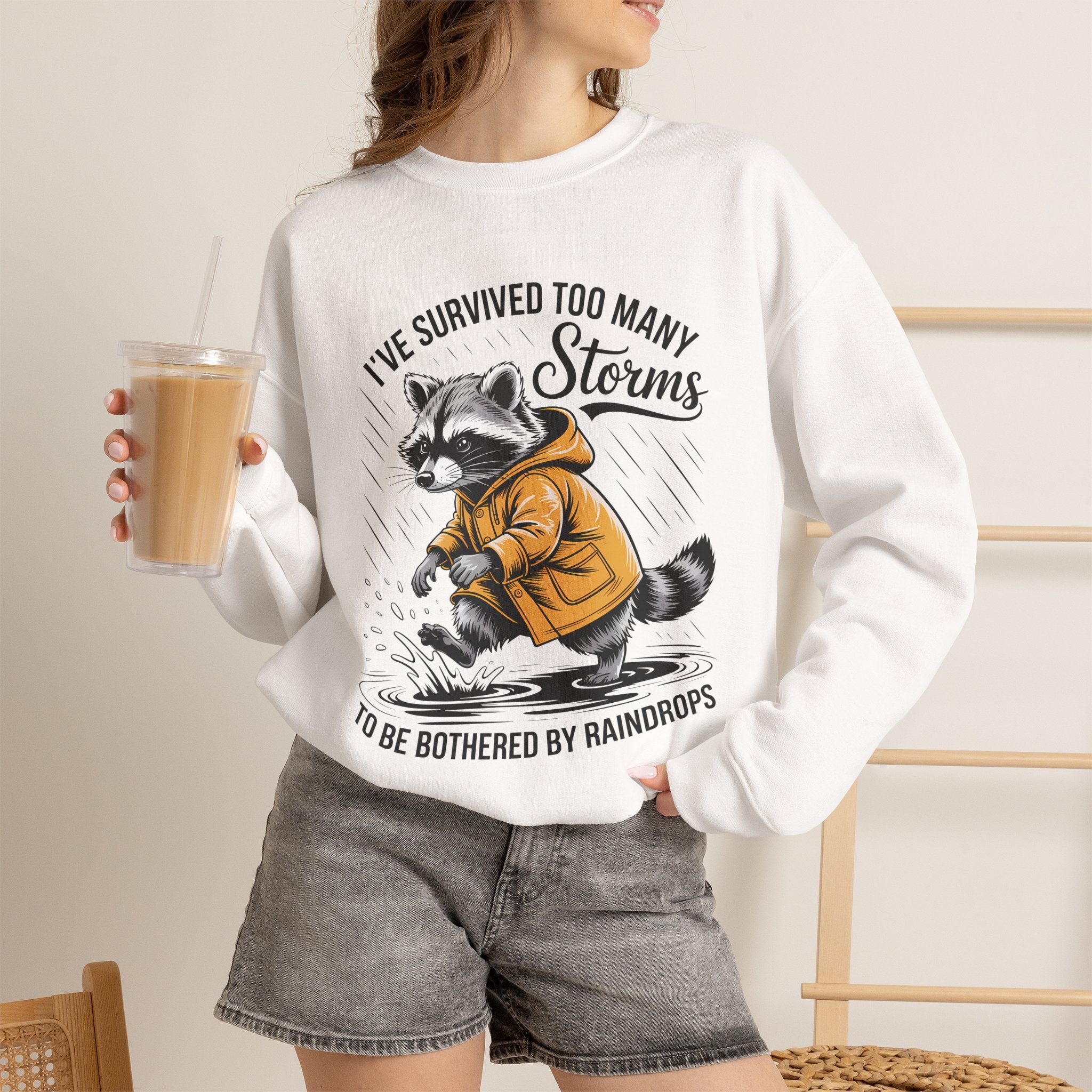 Crewneck Sweatshirt — "I've Survived Too Many Storms" Raccoon Graphic Unisex